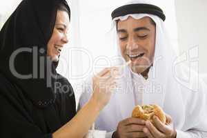 A Middle Eastern couple sharing a fast food meal