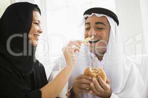 A Middle Eastern couple sharing a fast food meal