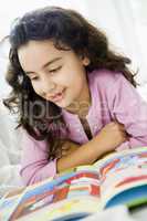 A Middle Eastern girl reading a book