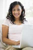 A Middle Eastern woman sitting with a laptop