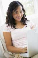 A Middle Eastern woman sitting with a laptop