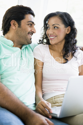 A Middle Eastern couple sitting with a laptop