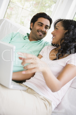 A Middle Eastern couple sitting with a laptop