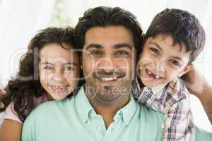 A Middle Eastern man with his children