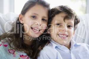 Portrait of two Middle Eastern children at home
