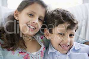 Portrait of two Middle Eastern children at home