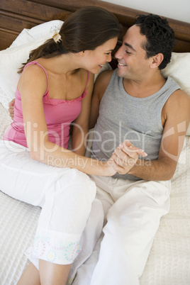 A Middle Eastern couple lying on a bed