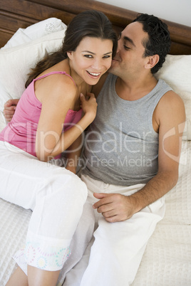 A Middle Eastern couple lying on a bed