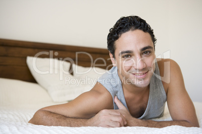 A Middle Eastern man lying on a bed