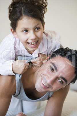 A Middle Eastern man playing with his daughter