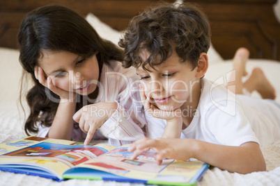 A Middle Eastern brother and sister reading together
