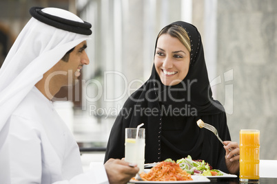 A Middle Eastern couple enjoying a meal in a restaurant
