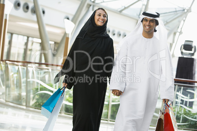 A Middle Eastern couple in a shopping mall