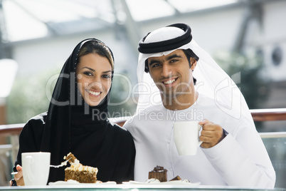 A Middle Eastern couple enjoying a meal in a restaurant