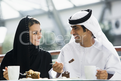 A Middle Eastern couple enjoying a meal in a restaurant