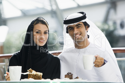 A Middle Eastern couple enjoying a meal in a restaurant