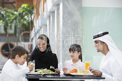 A Middle Eastern family enjoying a meal in a restaurant