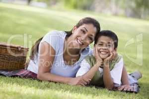 beautiful woman having picnic in the park with son