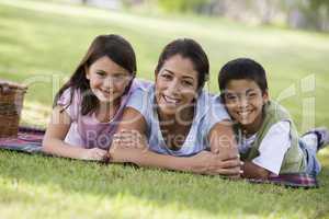 beautiful woman having picnic in the park with their kids