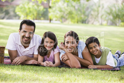 couple having picnic in the park with their kids