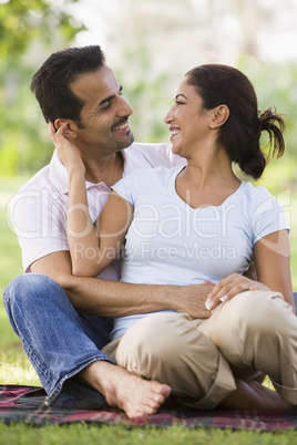 happy couple sitting in the park