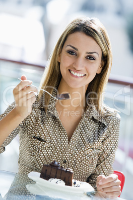 young woman eating chocolate cake