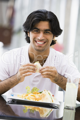 Young man eating a sandwich