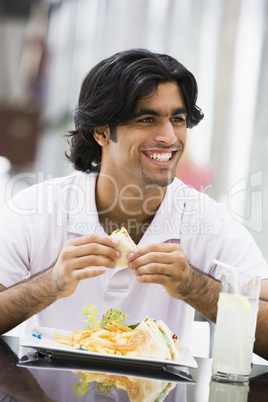 Young man eating a sandwich