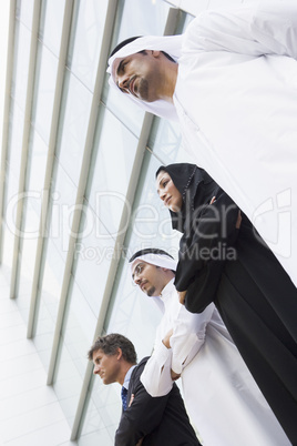 Four businesspeople in front of a tower building