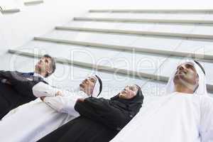 Four businesspeople in front of a tower building