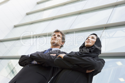Two businesspeople in front of a tower building