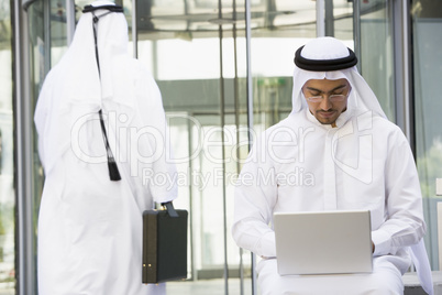 A Middle Eastern businessman using a laptop ,