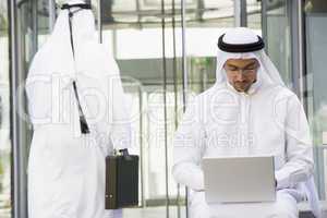 A Middle Eastern businessman using a laptop ,