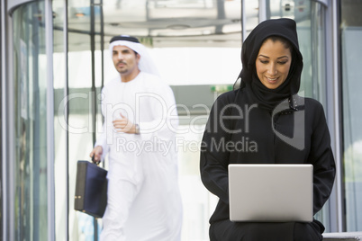 A Middle Eastern businesswoman using a laptop