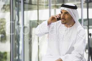A Middle Eastern businessman using a cellphone