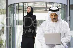 A Middle Eastern businessman using a laptop