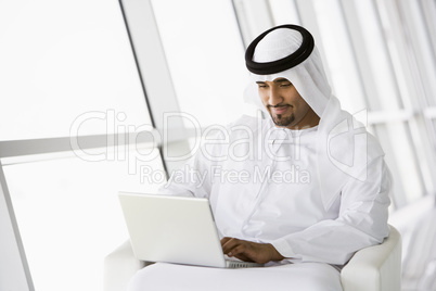 A Middle Eastern businessman using a laptop