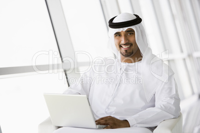 A Middle Eastern businessman using a laptop