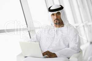 A Middle Eastern businessman using a laptop