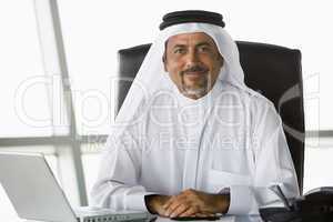 A Middle Eastern businessman using a laptop