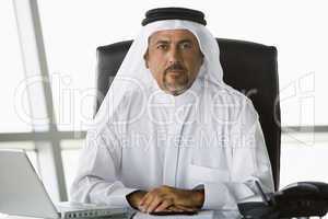 A Middle Eastern businessman using a laptop