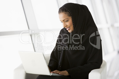 A Middle Eastern businesswoman using a laptop