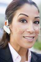 Businesswoman using bluetooth earpiece