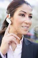 Businesswoman using bluetooth earpiece