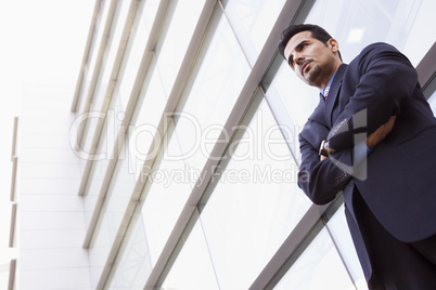 Businessman standing outside office building