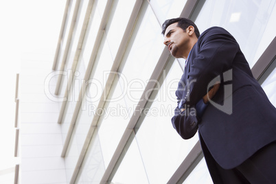 Businessman standing outside modern office