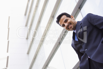 Businessman standing outside office building