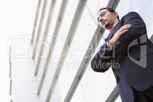 Businessman standing outside modern office