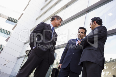 Group of businessmen talking outside office
