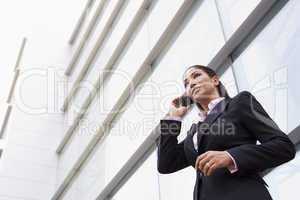 Businesswoman talking on cell phone outside